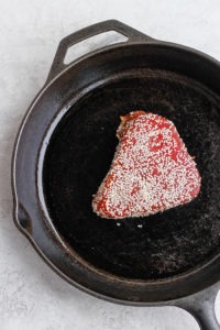 Seared ahi tuna cooked in a cast iron skillet.
