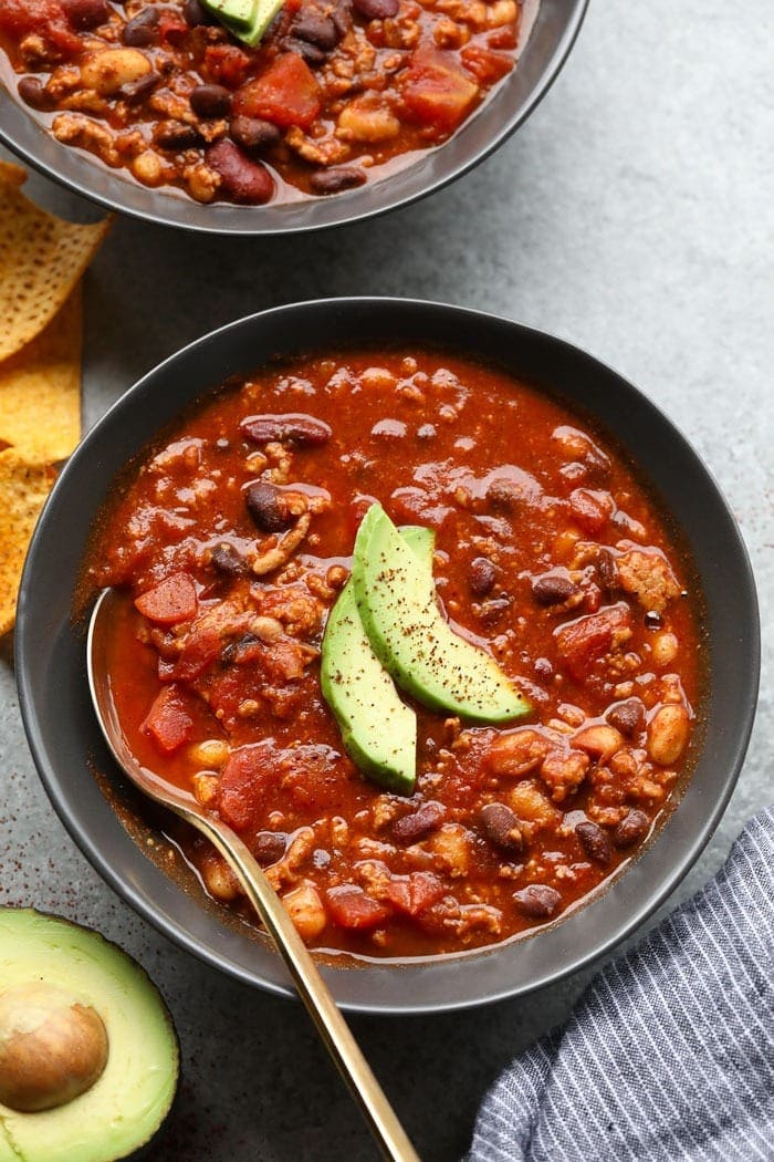 We're calling this turkey chili recipe a lazy girl chili because it's just that easy to make! It's made with ground turkey, beans, your favorite salsa, and chili seasoning. healthy turkey chili in bowl