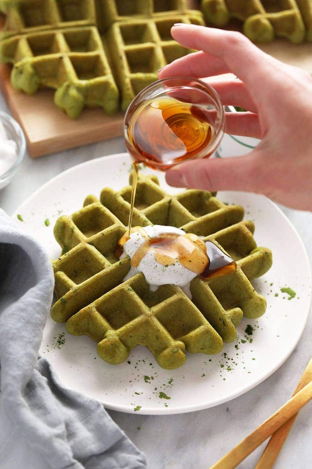 Make these amazing gluten free matcha waffles with just 9-ingredients including matcha powder, which is what turns them green. green tea waffles with syrup