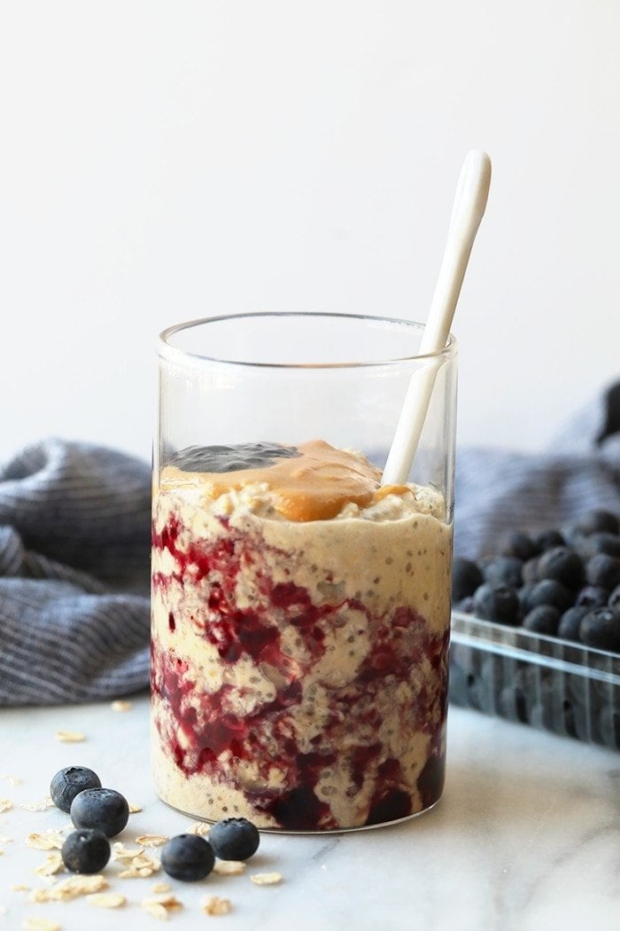 These PB & J Overnight oats are made with a peanut butter overnight oatmeal base and topped with your favorite jelly giving you tons of fiber, protein, and a whole lotta lovin'. pb and j oats in a jar