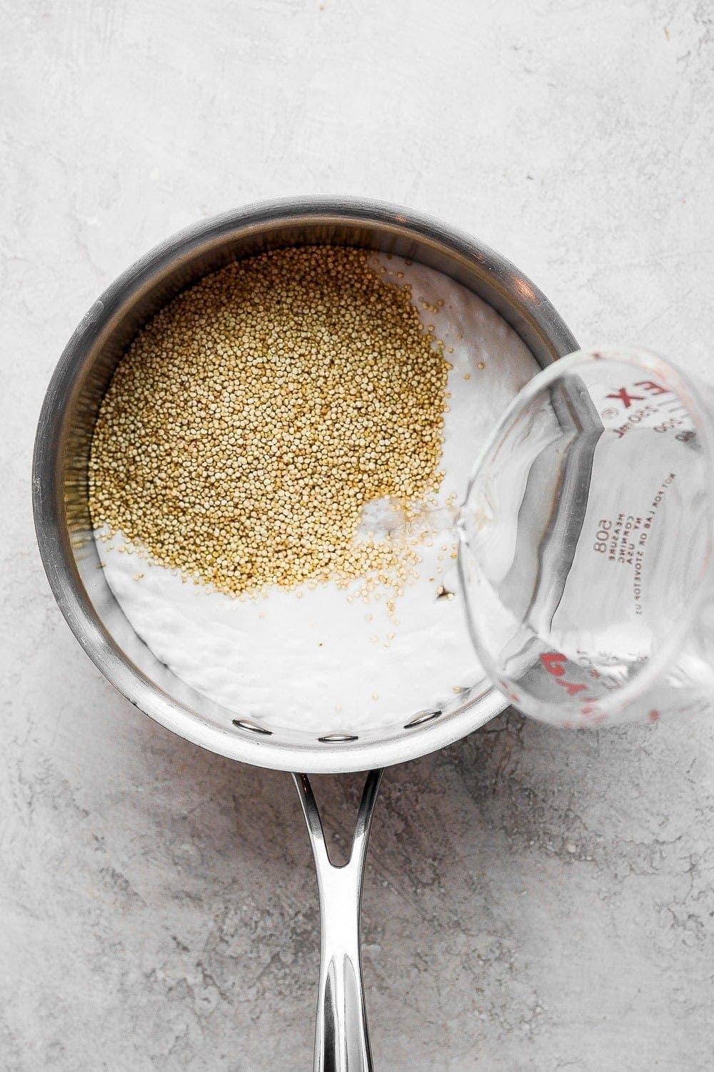 Quinoa and coconut milk in a sauce pan