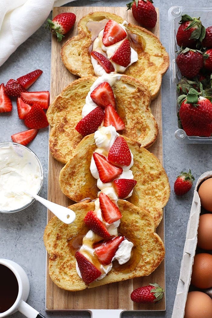 This Strawberries and Cream French Toast for two is the perfect special breakfast for any occasion. It's made with yummy sourdough bread and a homemade lightened up whipped topping! French toast with berries and whipped cream