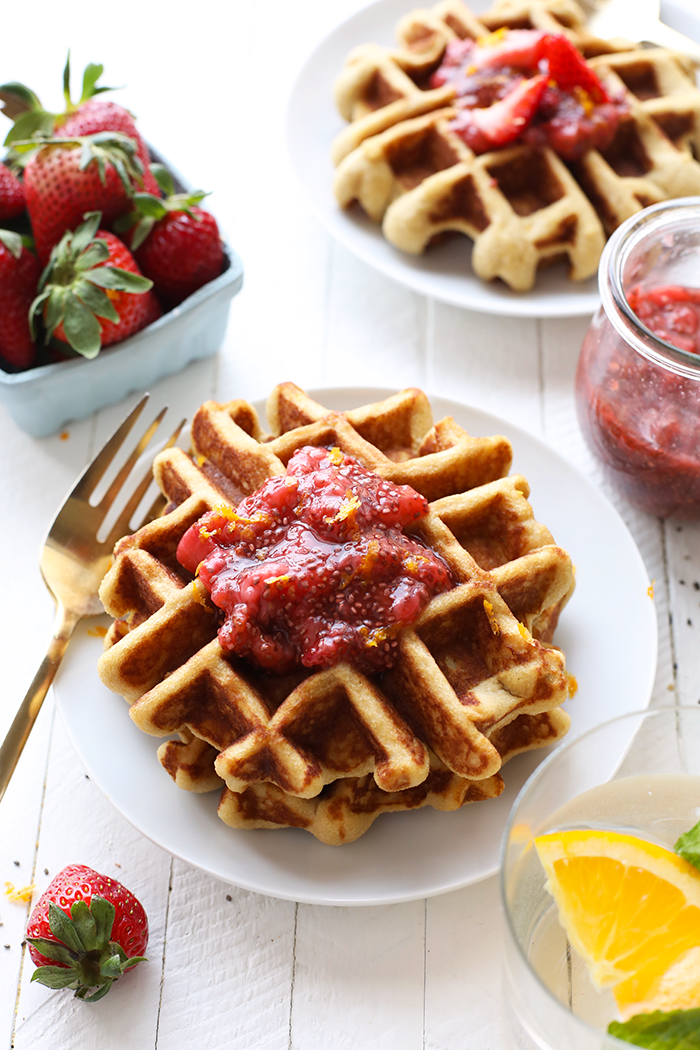 Looking for a simple gluten free waffle recipe? These gluten free waffles are a staple in our kitchen made with the base of almond and coconut flour! waffles with chia seed compote on plate.