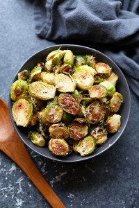 Roasted Brussels sprouts topped with parmesan in a bowl.