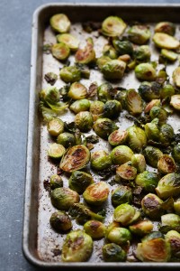 Roasted brussels sprouts with parmesan on a baking sheet.