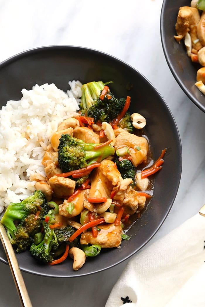 Homemade Chicken Stir Fry is an easy alternative to takeout and better for you. It's ready to go in less than 30 minutes and the kids will love it. chicken stir fry in bowl with rice