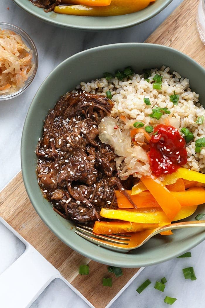 Start your week off right with this Instant Pot Korean Beef Bowl recipe. Your family and friends will absolutely love this meal! It tastes fancy but only takes a couple hours to prepare this fall-off-the-bone shredded Korean beef with your Instant Pot. Korean Beef in a bowl
