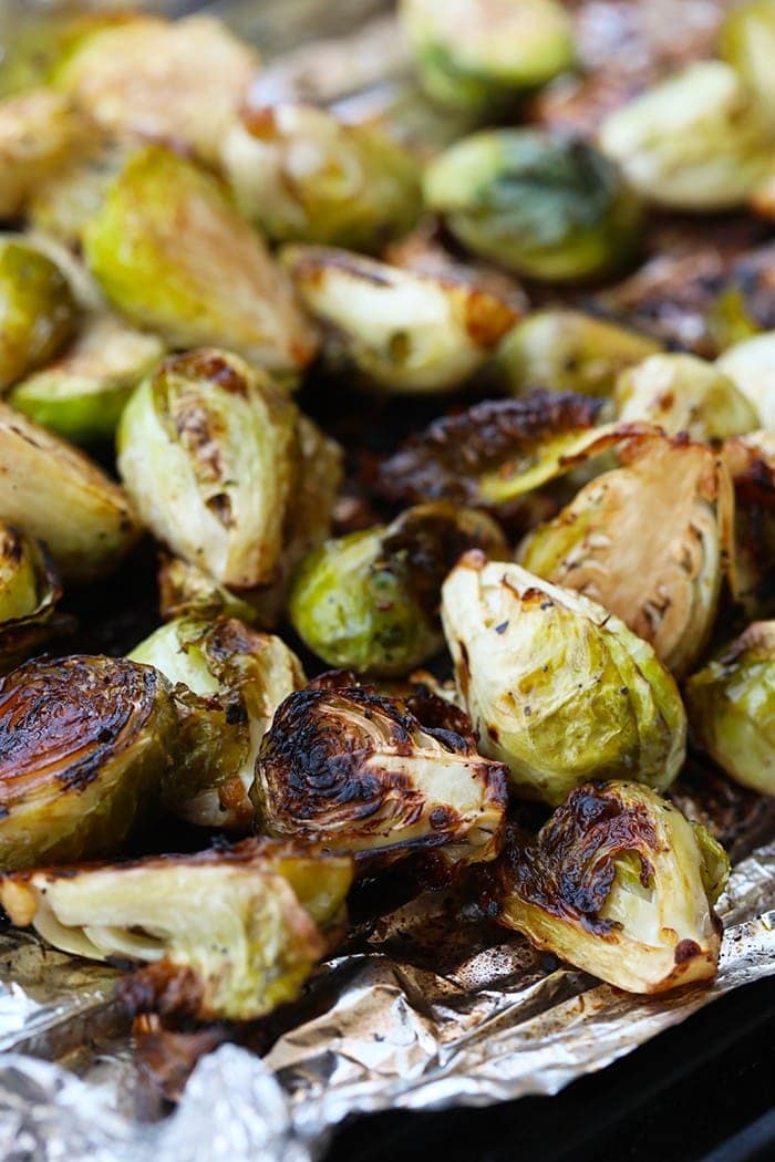 This Grilled Brussel Sprouts Recipe is perfect for a quick and easy weeknight dinner side or meal-prep for the week! You can use this recipe for grilled brussel sprouts, roasted brussel sprouts, or baked brussel sprouts. They are coated in balsamic, olive oil, and savory spices. Make them now! Grilled Brussel Sprouts on tin foil.