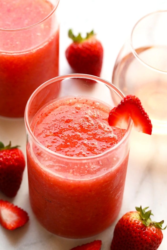 The most delicious summer drink you ever did see! This Strawberry Peach Frose recipe is such a fun frozen drink to make for a crowd. This easy frose recipe calls for a full bottle of rose, frozen strawberries and peaches, rum, and agave nectar! frose in a glass.