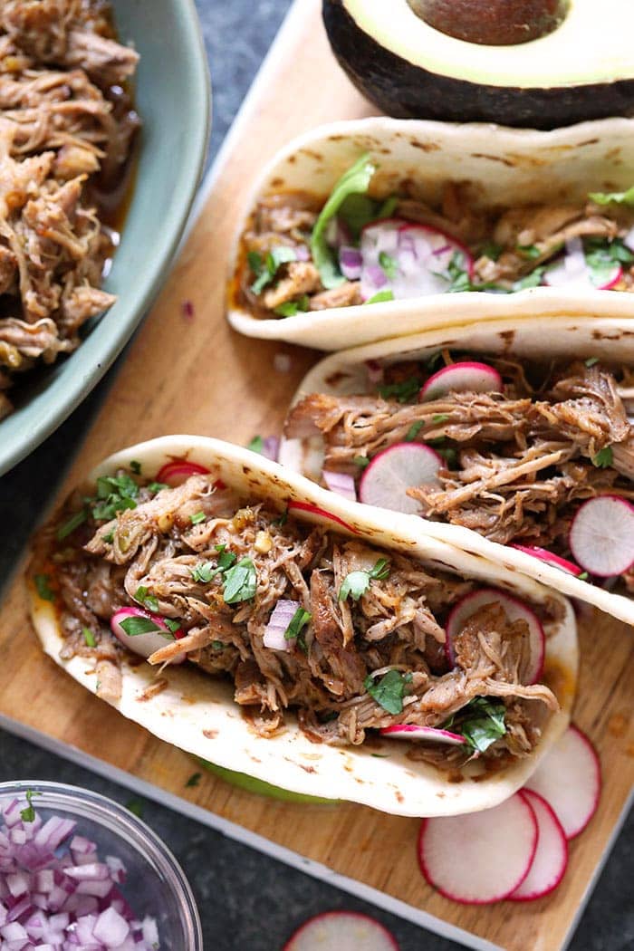 Is there anything better than fall off the bone pork carnitas tacos? Learn how to make the most delicious and juicy Instant Pot Pulled Pork Carnitas recipe with a few simple ingredients. carnitas tacos