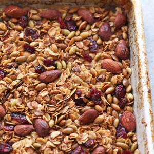 Healthy granola with nuts and cranberries in a baking pan.