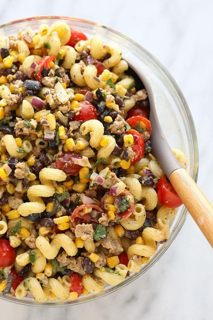 Our taco pasta salad is a fusion between beef tacos and pasta salad, leaving you will a hearty meal or side that the whole family will love. taco pasta salad in large bowl.