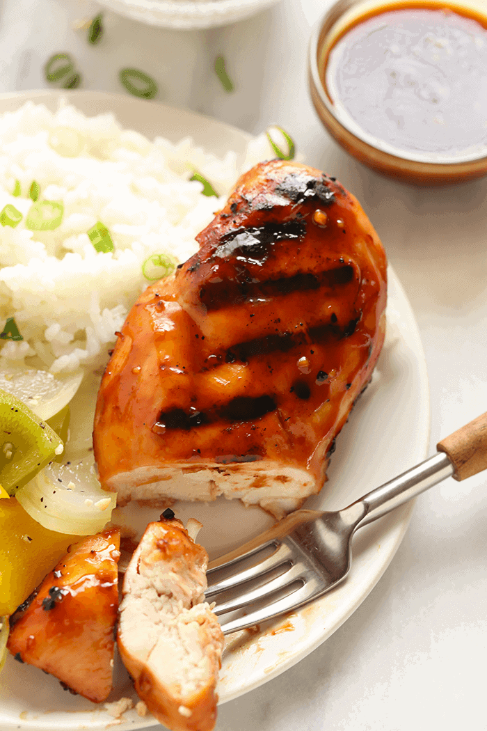 Our grilled teriyaki chicken is made with a simple homemade teriyaki chicken marinade and grill on the bbq! A sliced Teriyaki Chicken breast on a plate