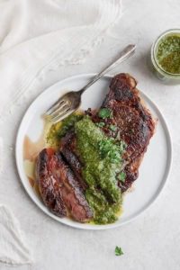 sous vide steak on plate with green sauce.