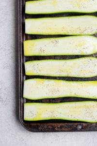 sliced zucchini on baking sheet.