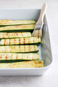grilled zucchini in casserole dish.