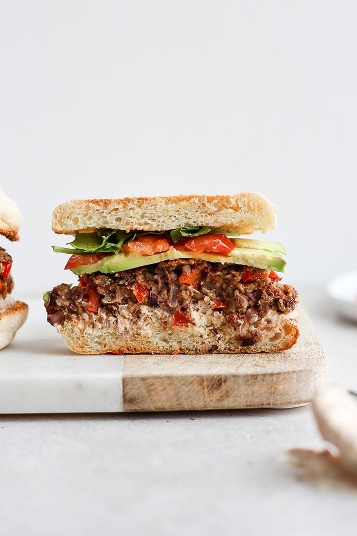 There has never been a more delicious black bean quinoa burger in all the land. Why is this black bean quinoa burger special? Because it is made with perfectly roasted garlic and is packed with veggies, protein, and dynamic flavor. Give it a try today! black bean burger in an english muffin