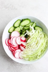 ahi poke bowl with radishes and cucumbers.