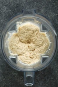 A bowl of cauliflower mashed potatoes in a food processor.