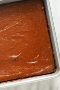 A delicious pumpkin cheesecake bar sits on a marble countertop.