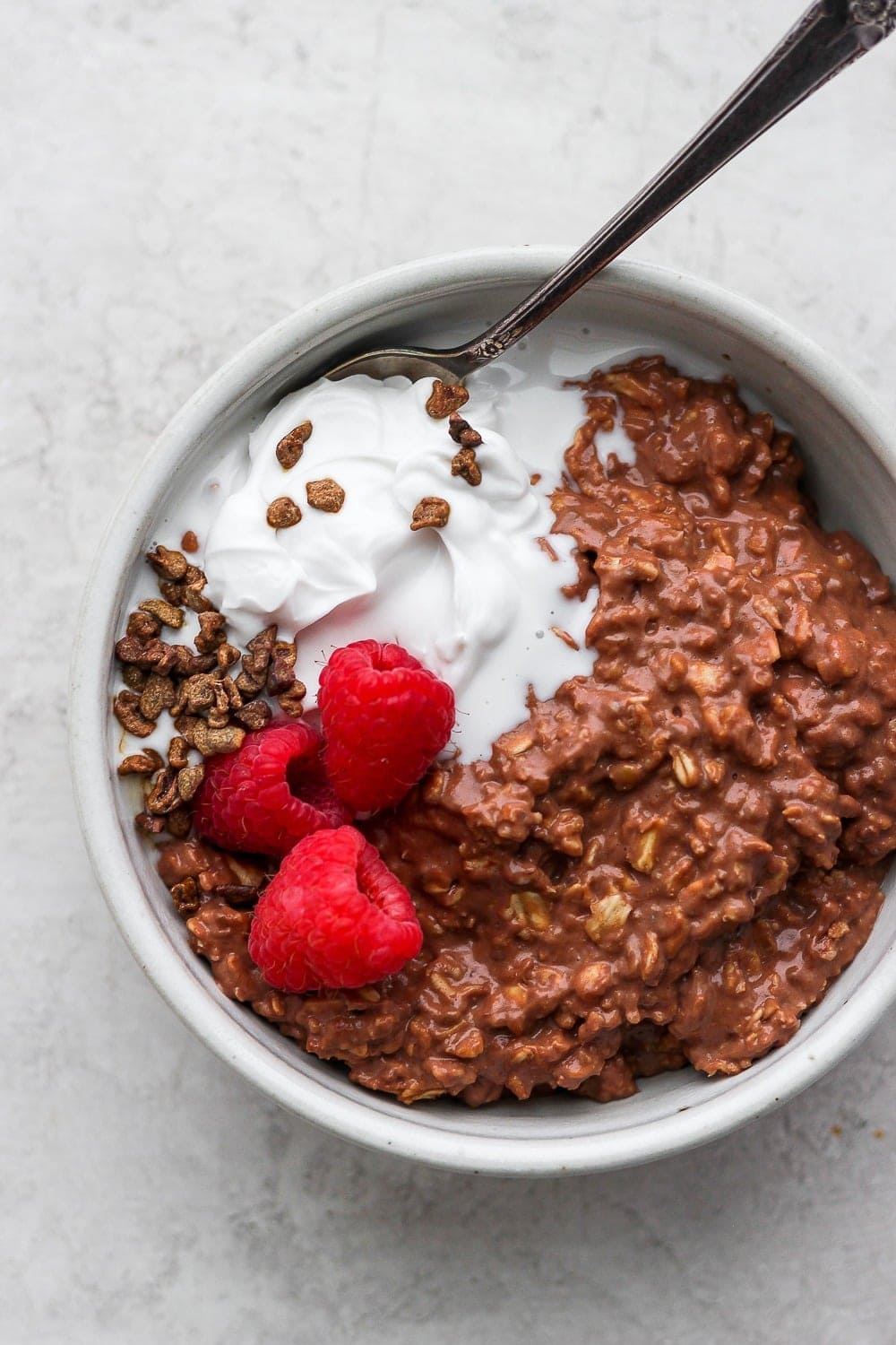 Say hello to your new favorite breakfast recipe! This Chocolate Sea Salt Protein Oatmeal is as delicious as it is nutritious. Packed with 29g of protein and 11g of fiber, you can't go wrong! chocolate sea salt protein oatmeal in a bowl