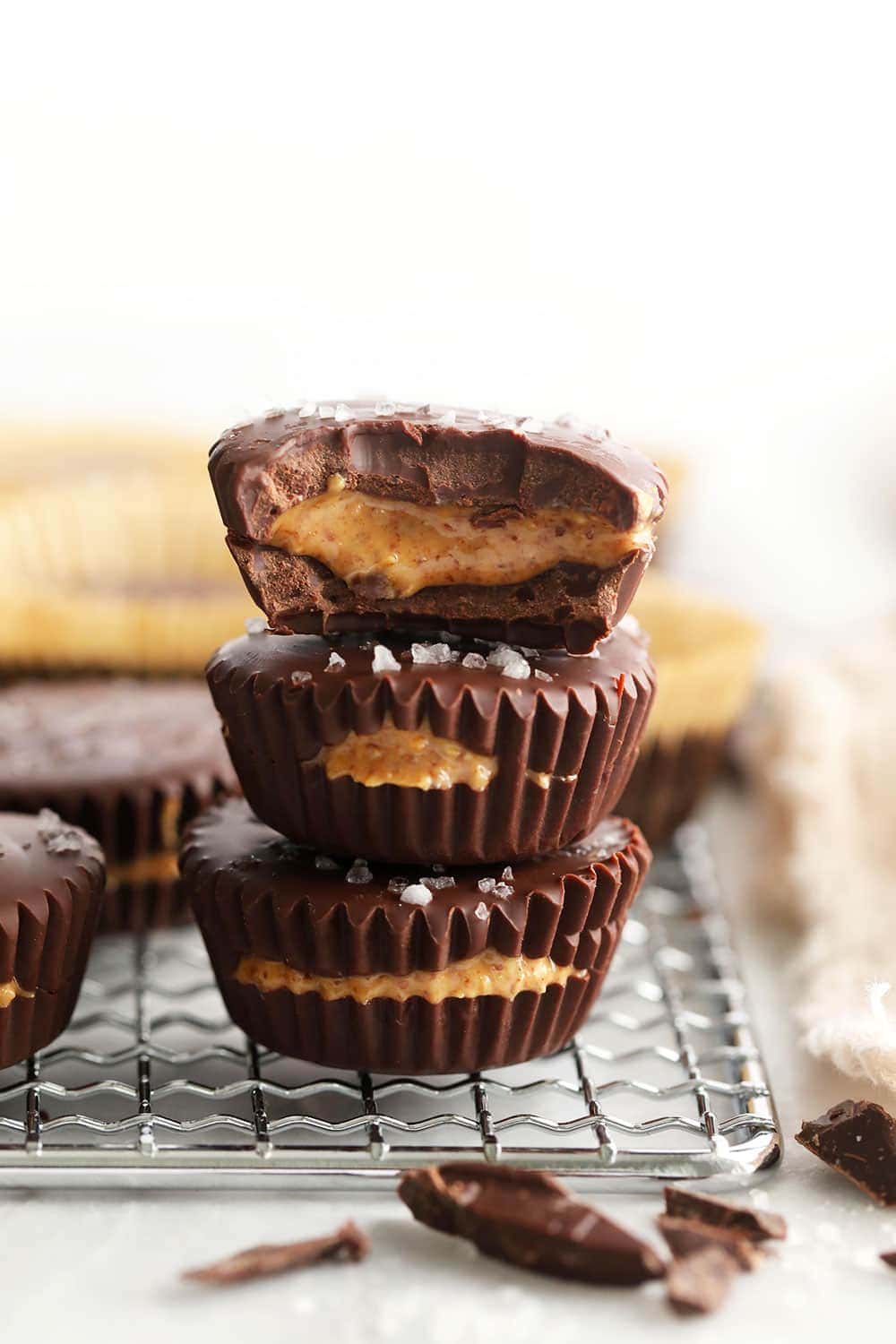 Homemade almond butter cups are a simple dessert that will satisfy your sweet tooth craving! Plus, these almond butter cups are topped with flakey sea salt. stacked almond butter cups