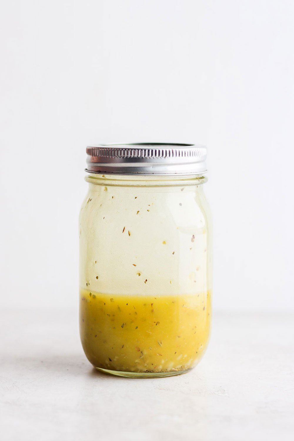 This Greek salad dressing recipe is tangy, sweet, and perfect for Greek salads, marinating meat, and more! Greek salad dressing recipe