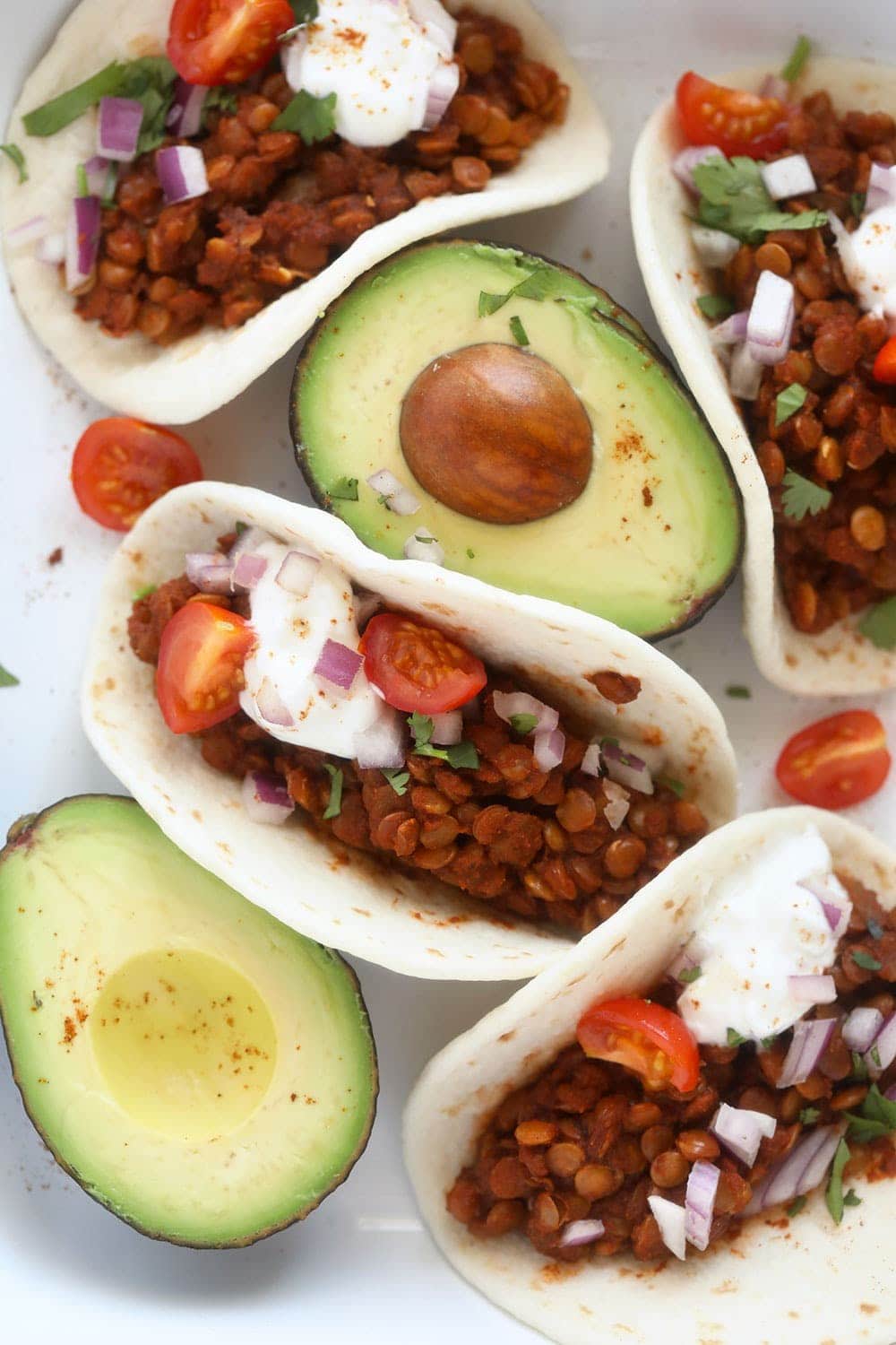 It only takes 5-ingredients to make this nutritious (and vegan!) Instant Pot Lentil Tacos recipe. Serve it on a tortilla, in a bowl or on nachos! Instant Pot Lentil Tacos on a platter
