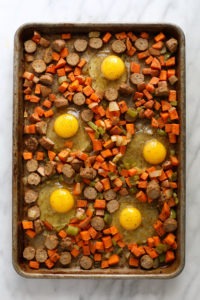 eggs and veggies on baking sheet.