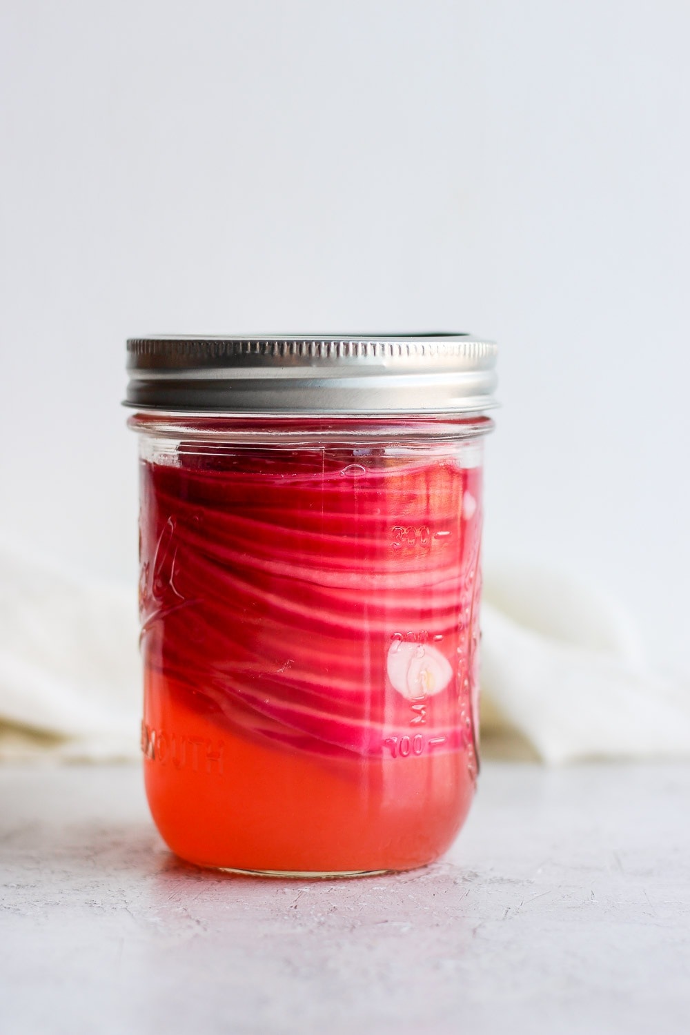 These quick pickled onions are a dream! Toss red onion with apple cider vinegar, white vinegar, a little sugar and salt. Throw them in the fridge and 2 hours later you've got pickled onions for dinner and the week ahead! Pickled Onions in a jar