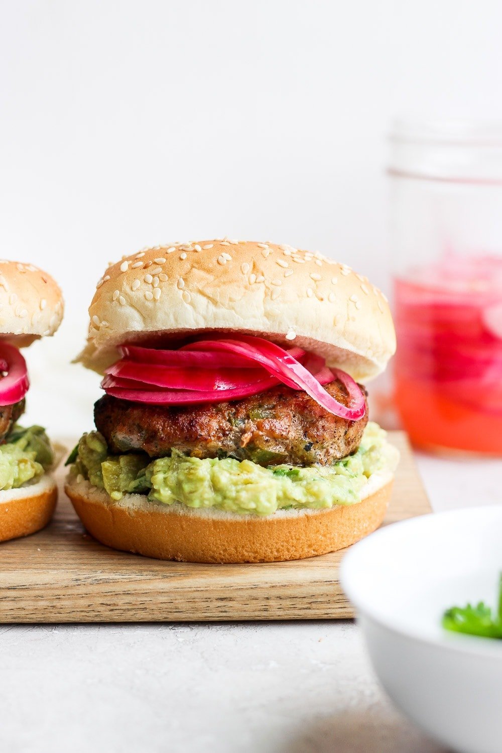 Say hello to the Best Juicy Turkey Burger you've ever had! These turkey burgers are always delicious, and never dry. Enjoy! turkey burgers on a bun, ready to be served.