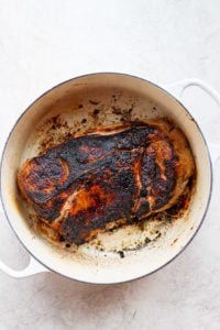 A baked pork roast on a white surface.