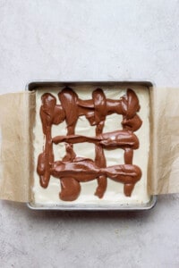 A brownie with chocolate icing in a baking pan.