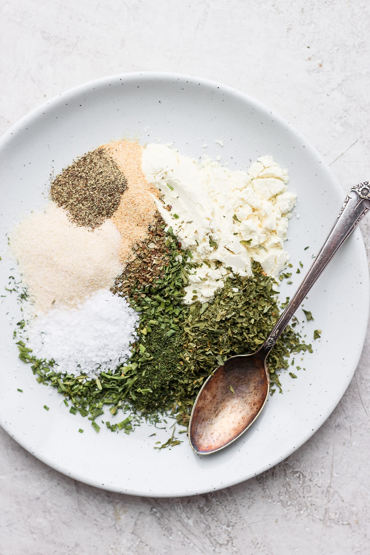 The best homemade ranch seasoning recipe on the internet. You'll want to have a jar of this ranching seasoning over any store-bought packet...trust me! Ranch spices on a plate.