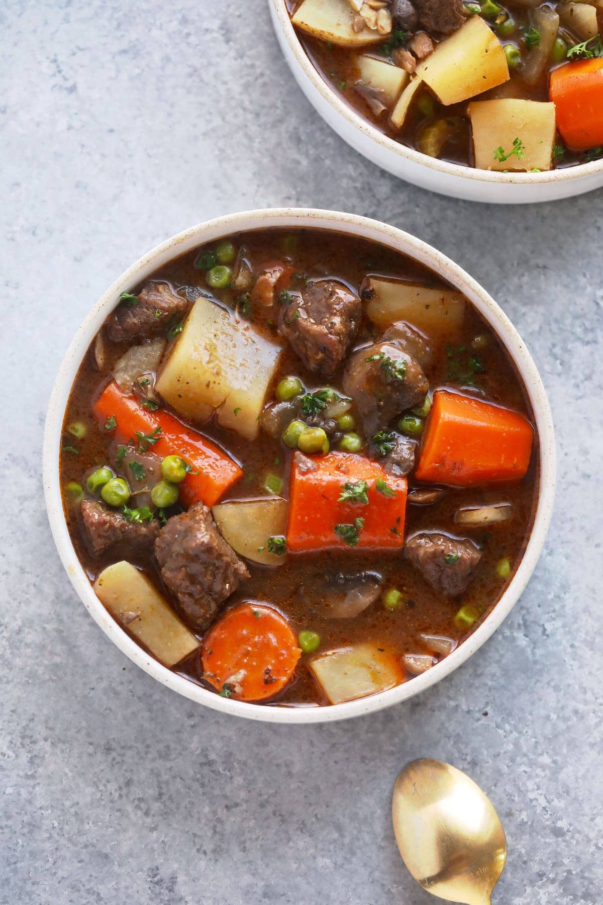 This is the most tender and flavorful Slow Cooker Beef Stew you'll ever have! Fall apart beef and tons of veggies make this beef stew the perfect (and healthy!) cozy comfort meal. slow cooker beef stew in a bowl ready to be served