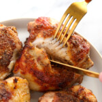 Chicken thighs on a plate.