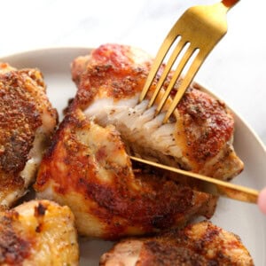 Chicken thighs on a plate.