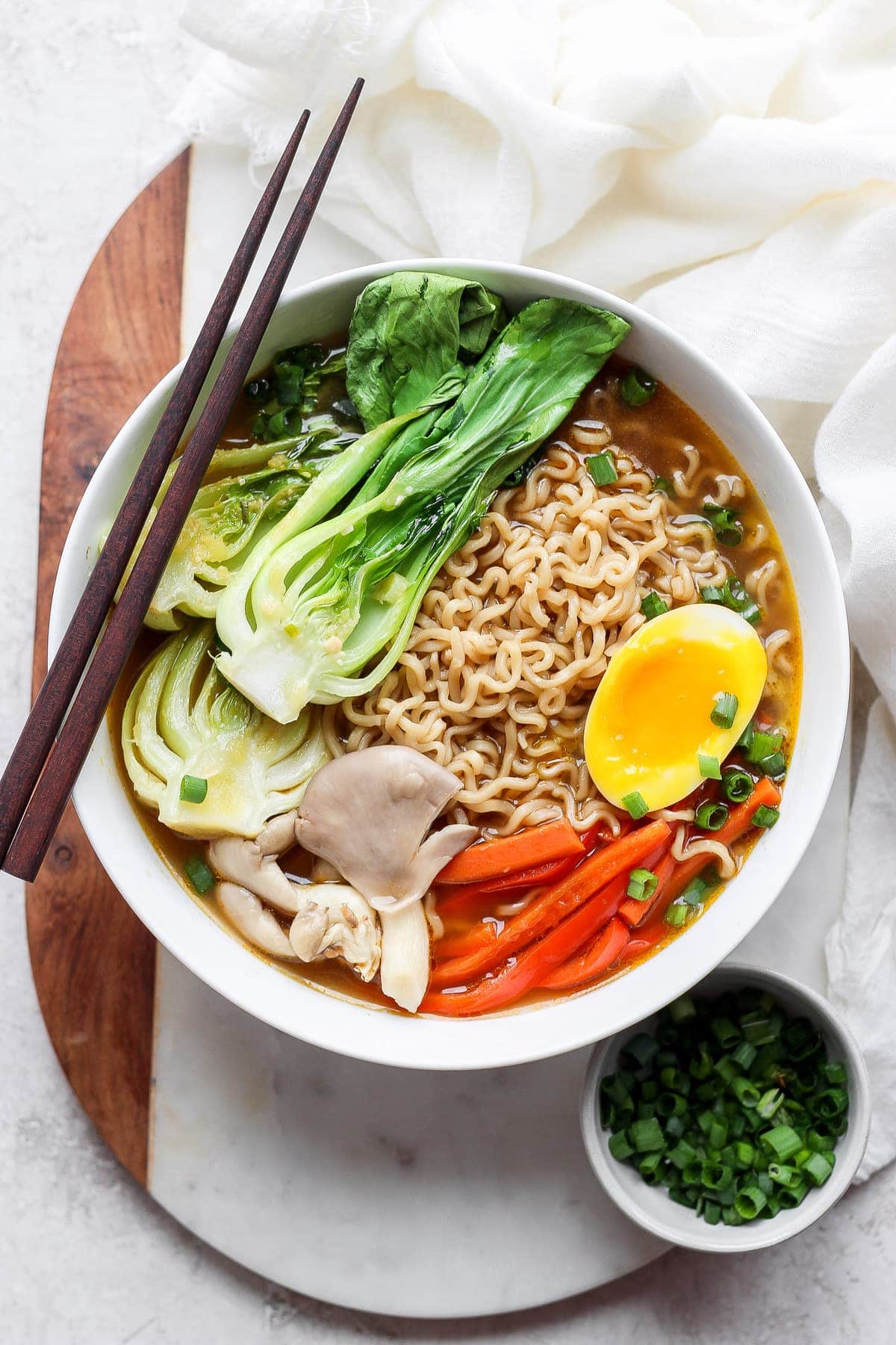 Ramen in a bowl with a soft boiled egg.