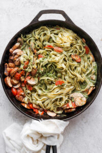 a skillet filled with pasta and vegetables.