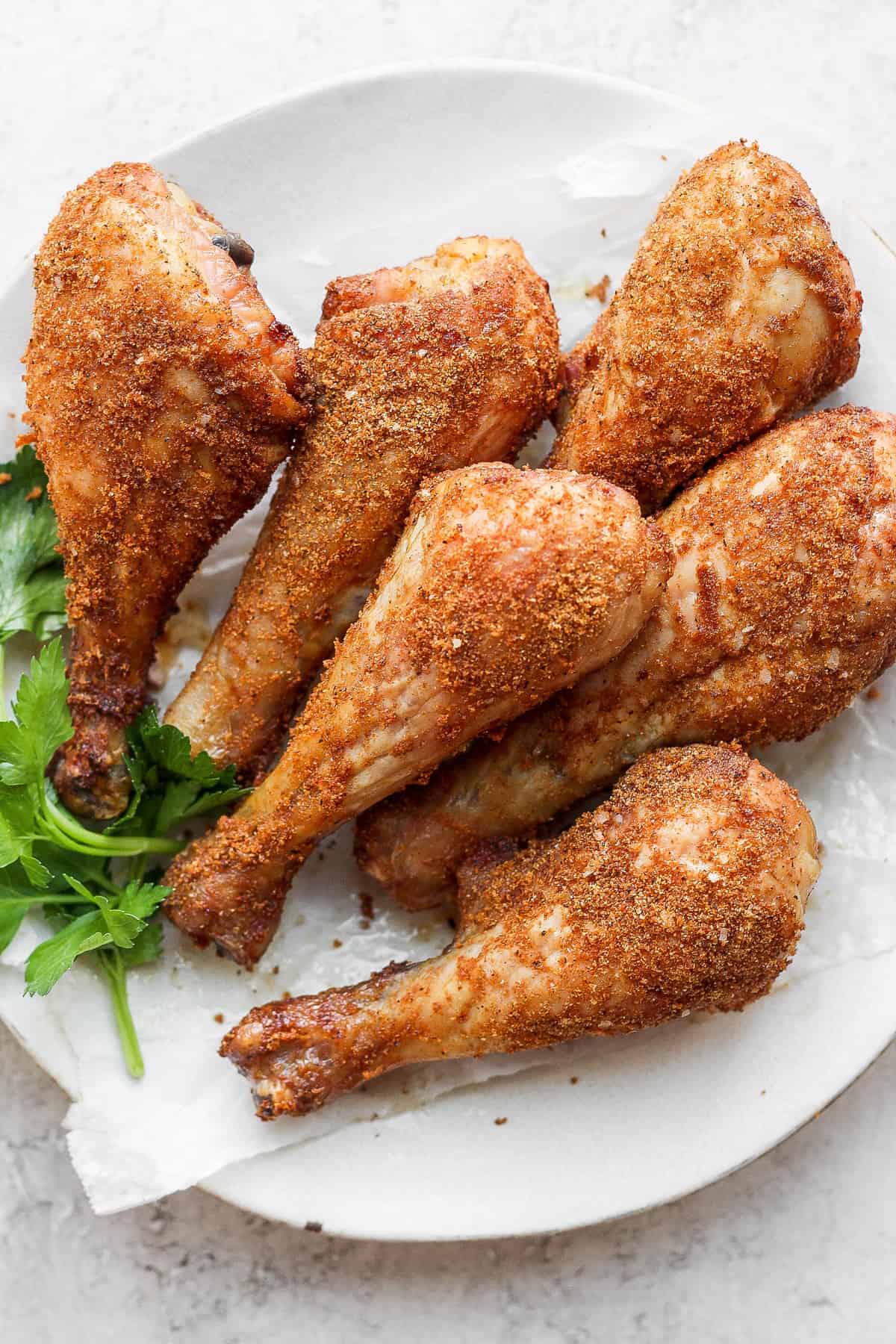 These smoked chicken legs are tender on the inside and crispy on the outside made with a simple dry rub. chicken legs on plate