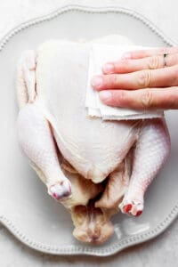 patting chicken dry.