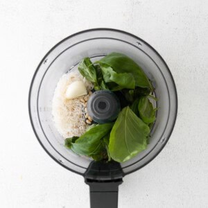 A food processor filled with vegetables and rice.