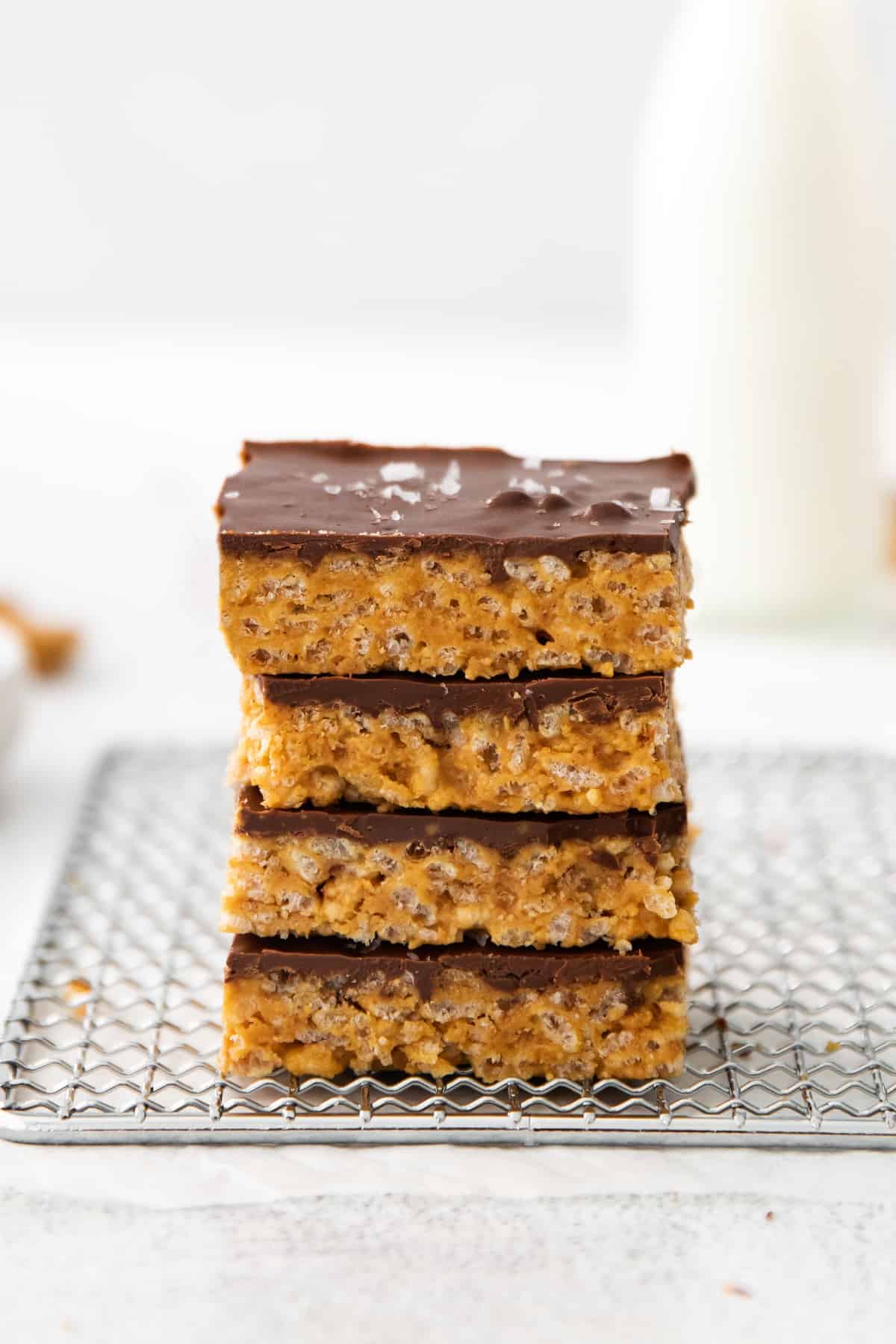 These healthy scotcheroos are made with all natural sugar, unsalted peanut butter, and coconut oil (no white sugar or corn syrup)! They are ready in no time and a great healthy spin on this classic dessert bar. healthy scotcheroo bars stacked together