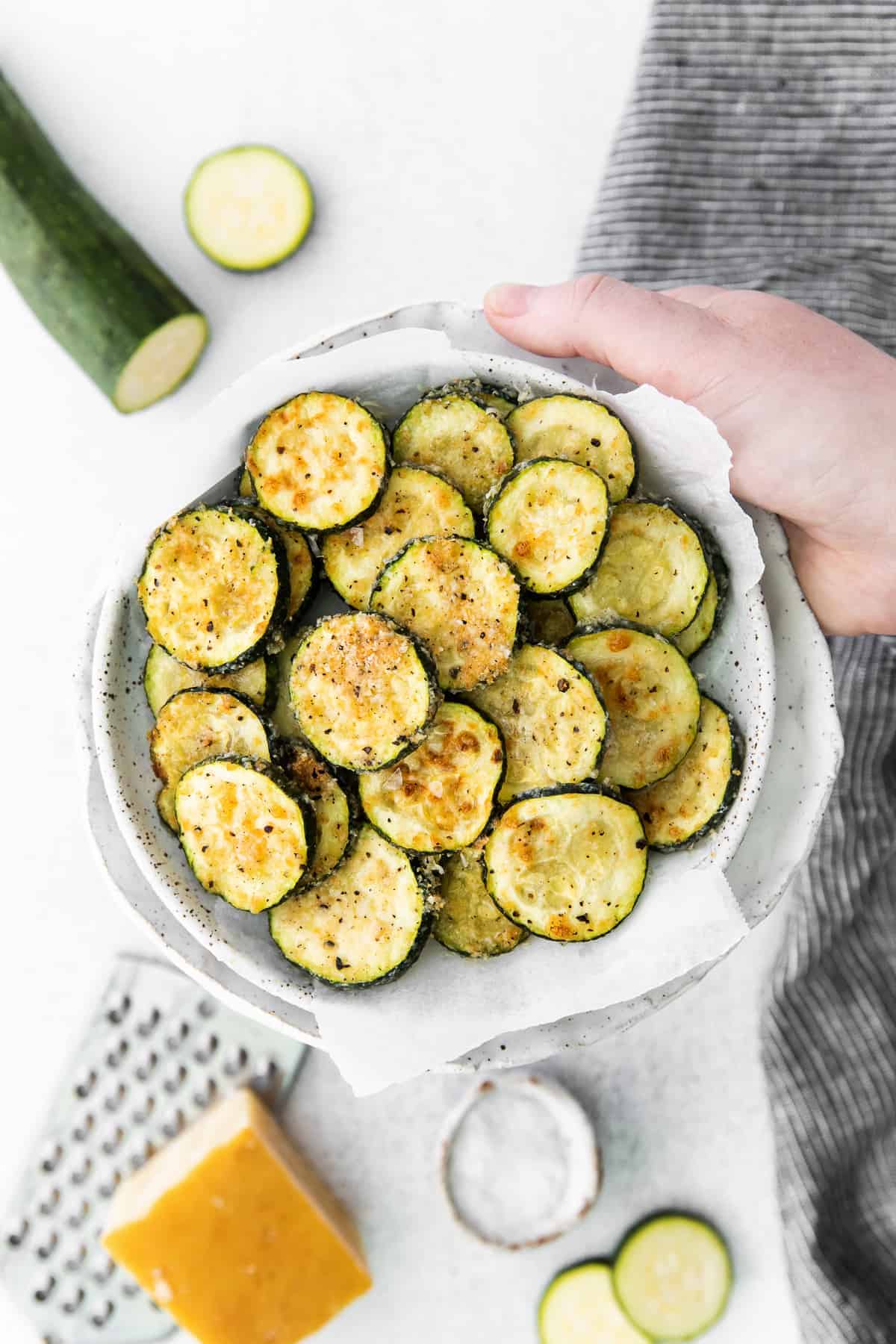 This perfectly cooked Air Fryer Zucchini is tossed in garlic and parmesan cheese and comes out so tasty! air fryer zucchini in a bowl.