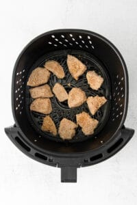 a black basket with brown food in it.