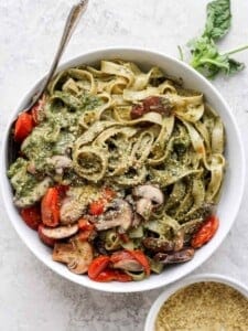 a bowl of vegan pesto pasta