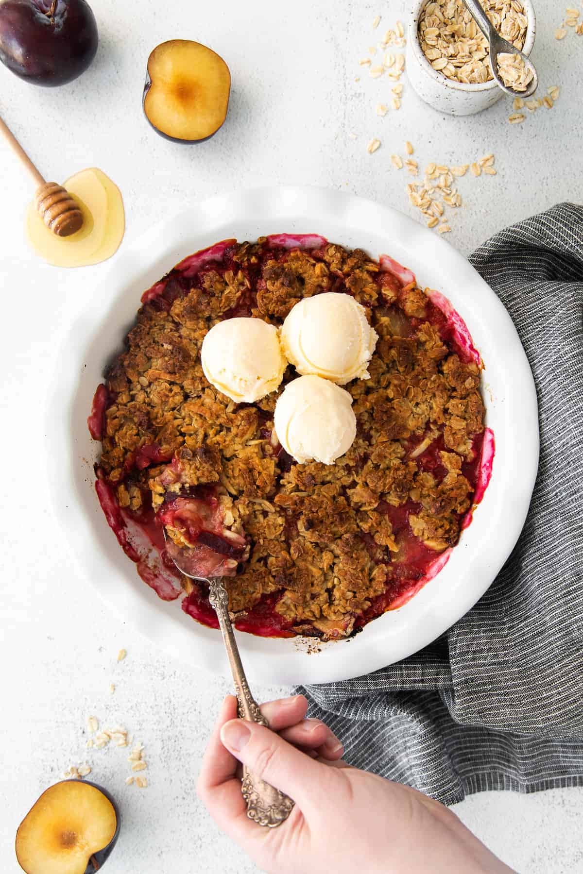 The most gorgeous and delicious plum crisp you've ever tasted. Made with juicy, fresh plums and a buttery crisp topping, this is the perfect summer crisp recipe. plum crisp in circular dish