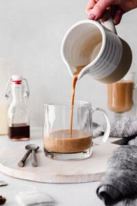 A person pouring coffee into a mug.