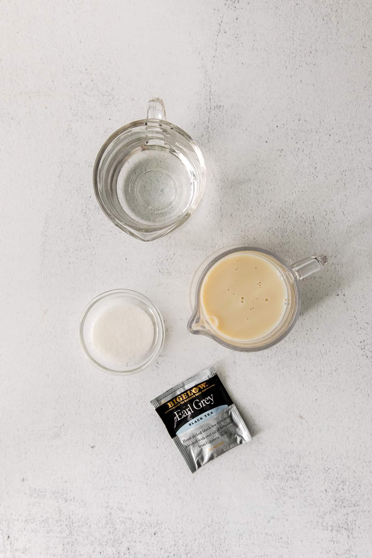 ingredients for a london fog drink in cups and mugs