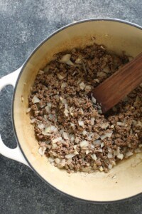 beef and onions in pot.
